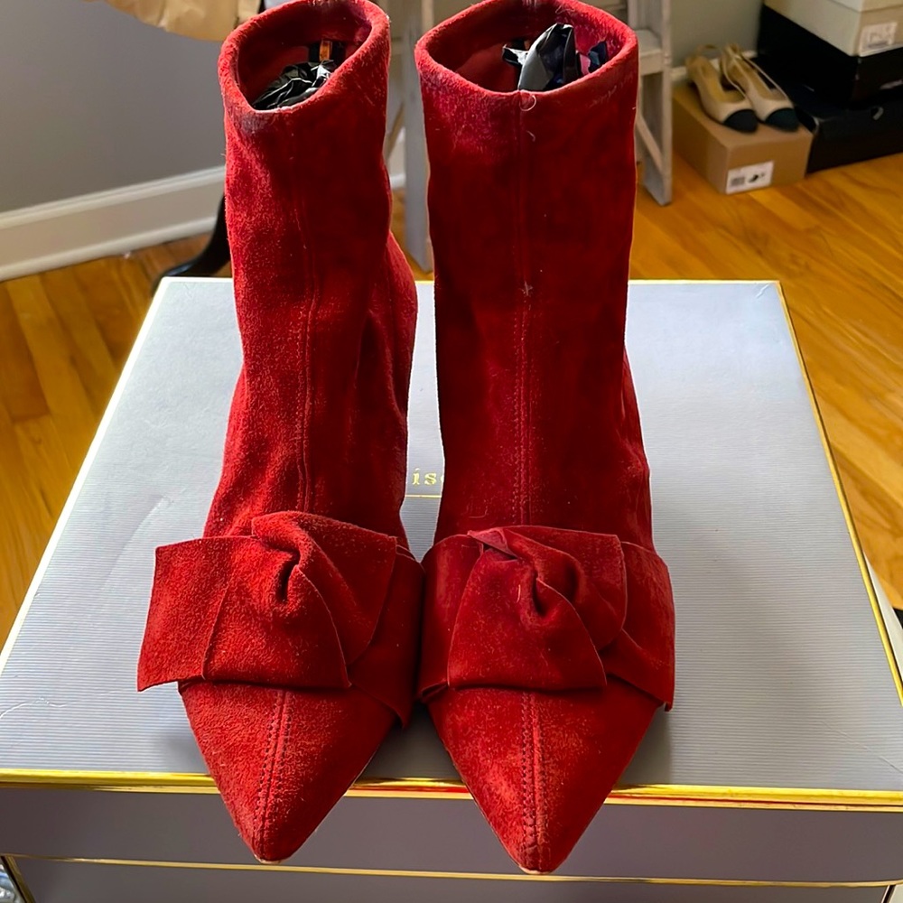 Suede rust-orange booties with bow detail.